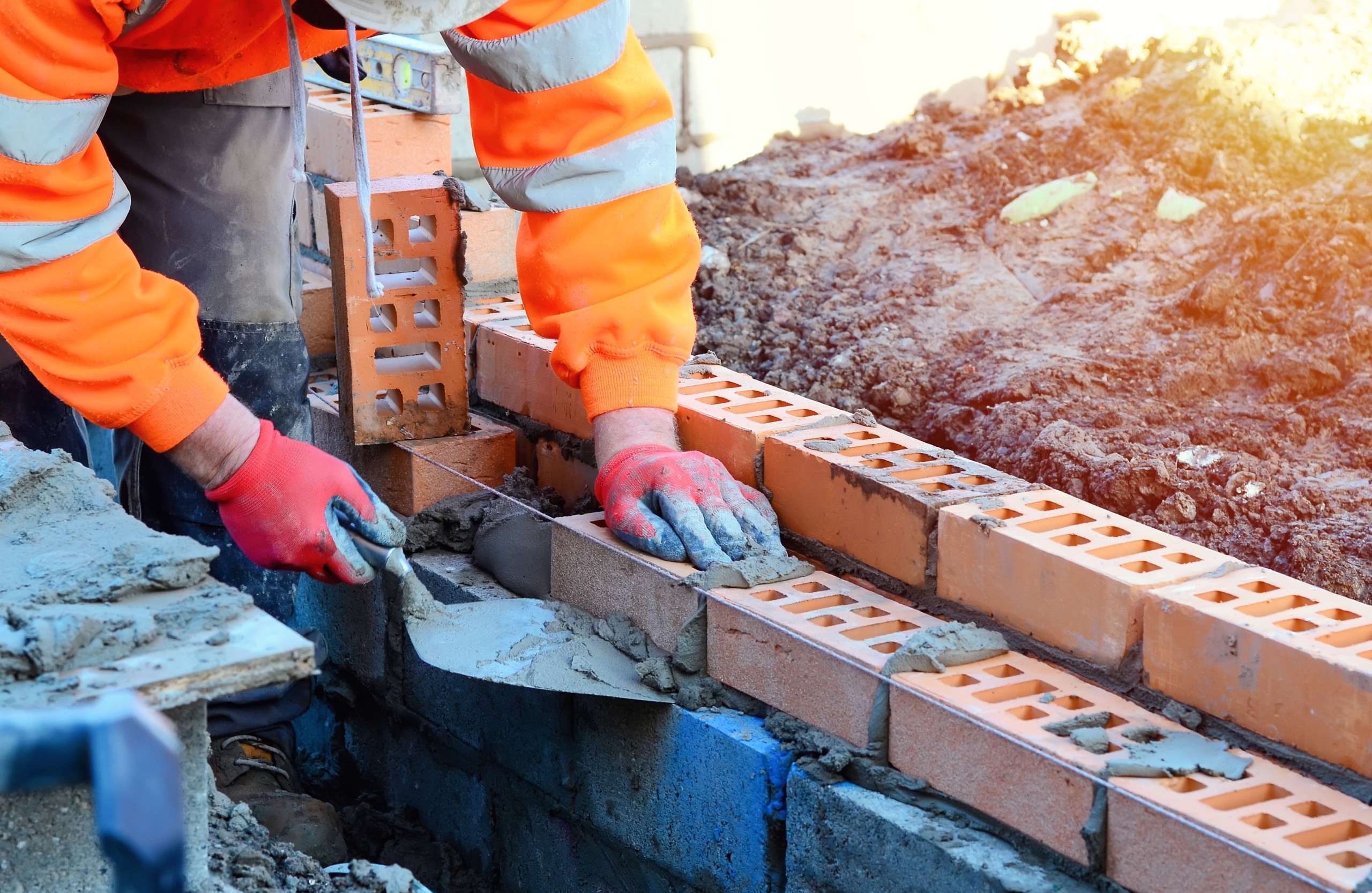 A bricklayer working on a construction site.