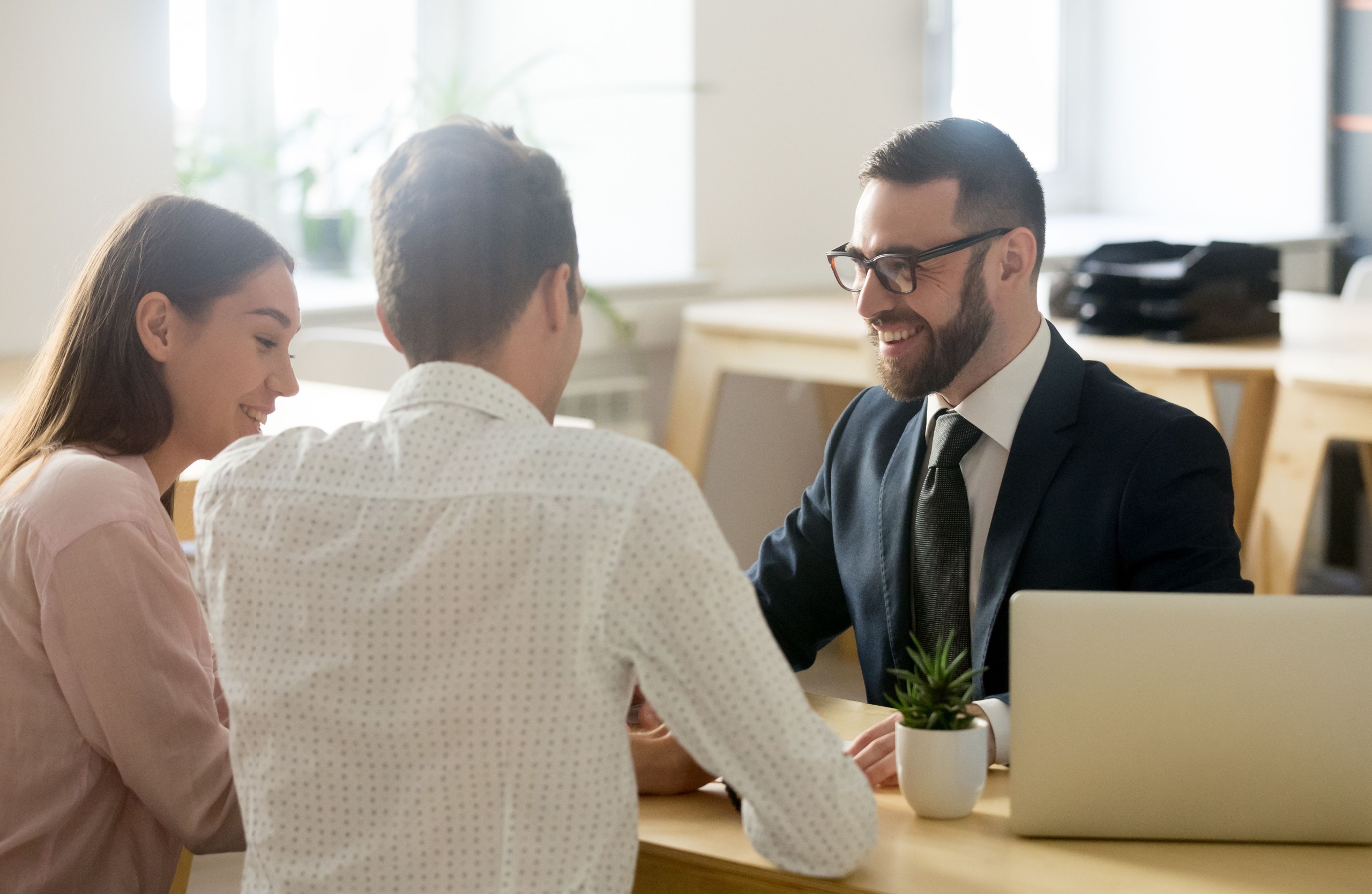 A young couple meeting with a financial planner.