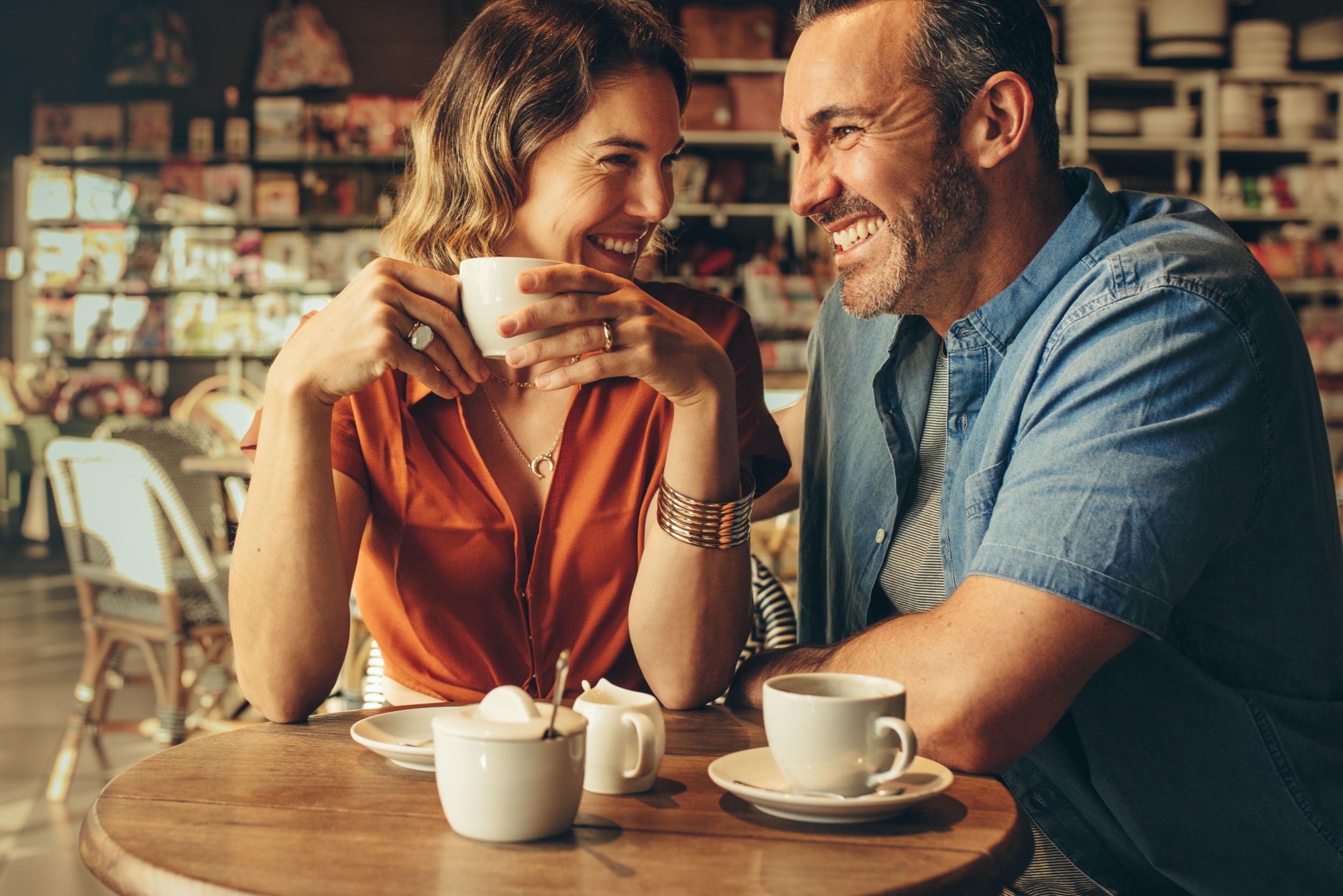 A couple laughing in a café