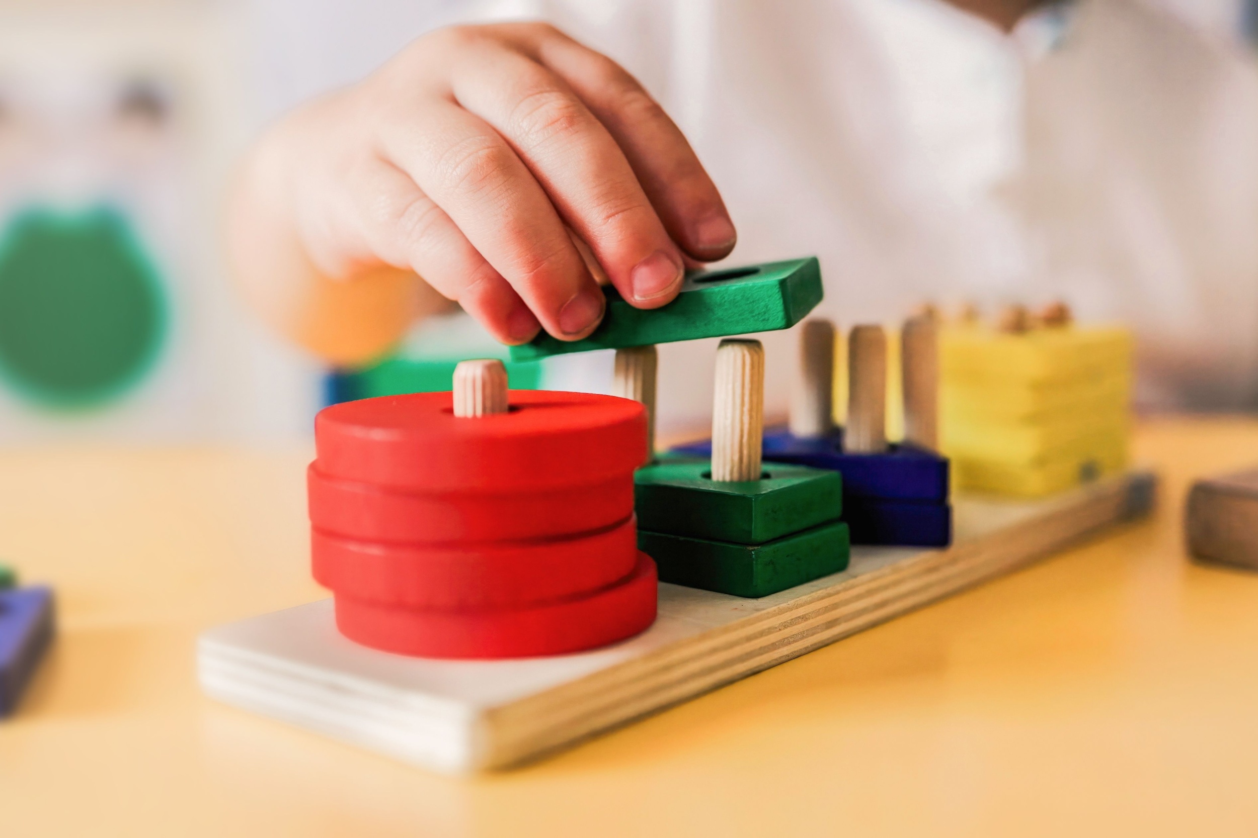 A child playing with wooden shapes.