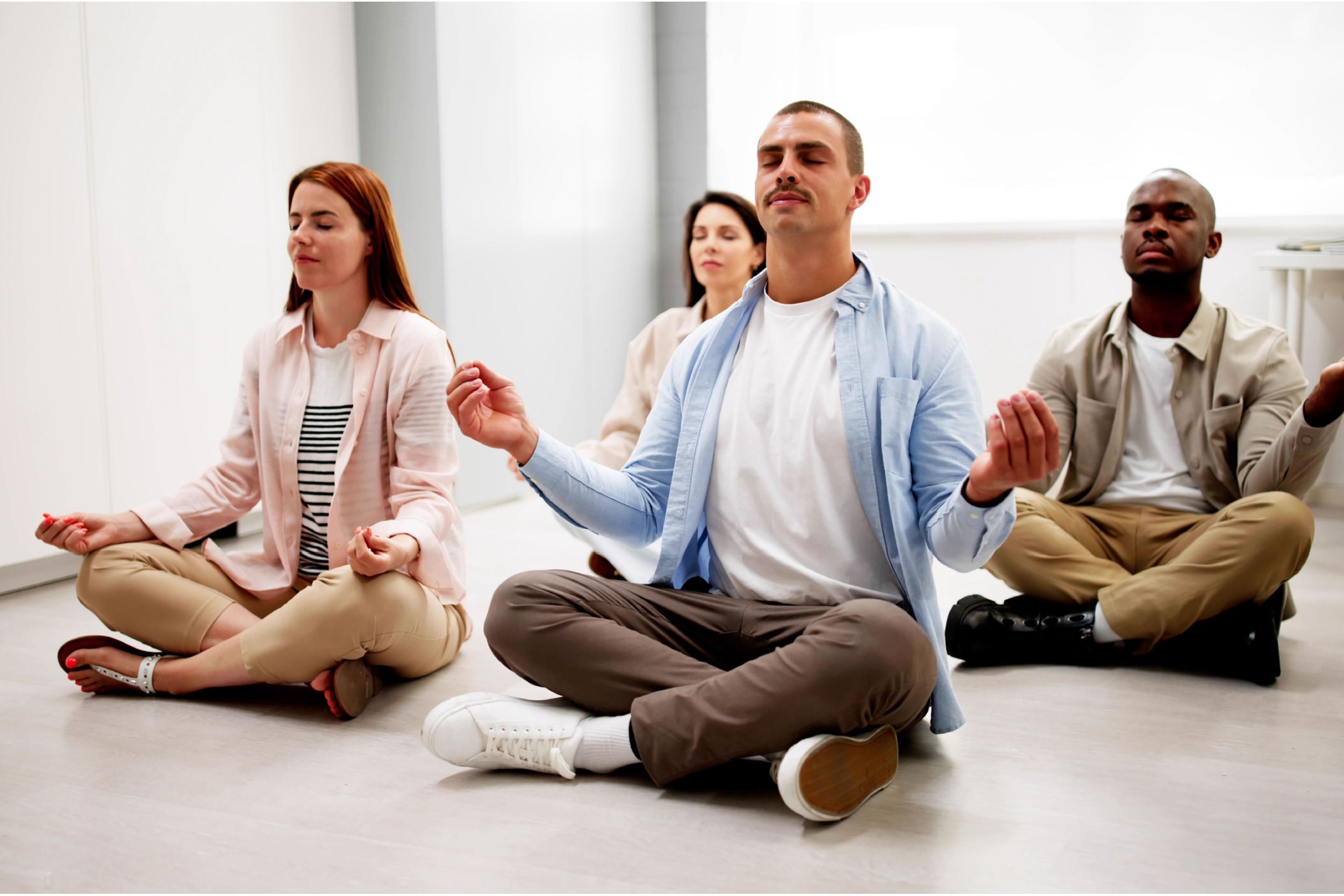 Group of employees meditate in an office