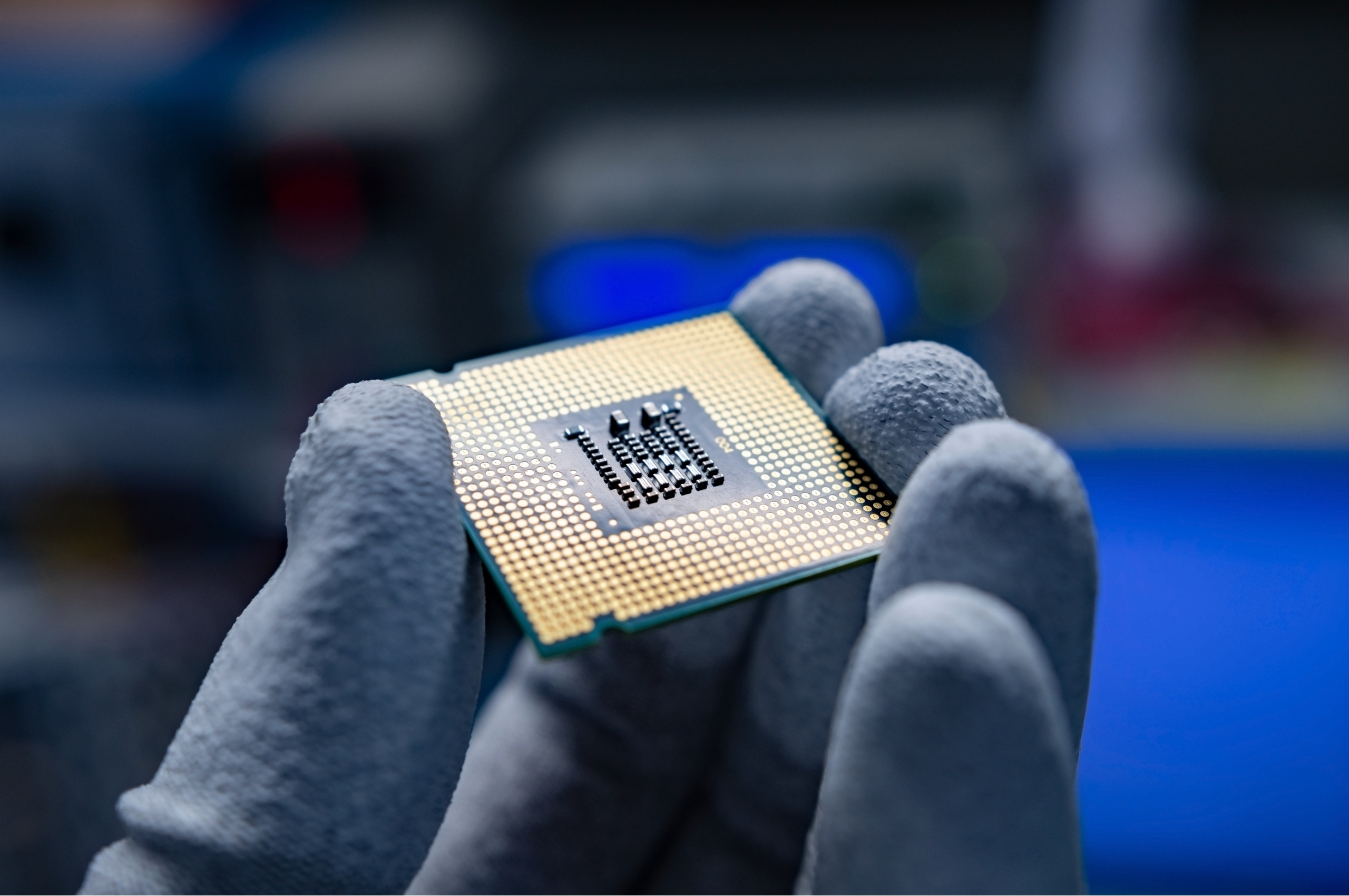 A hand holding a CPU.