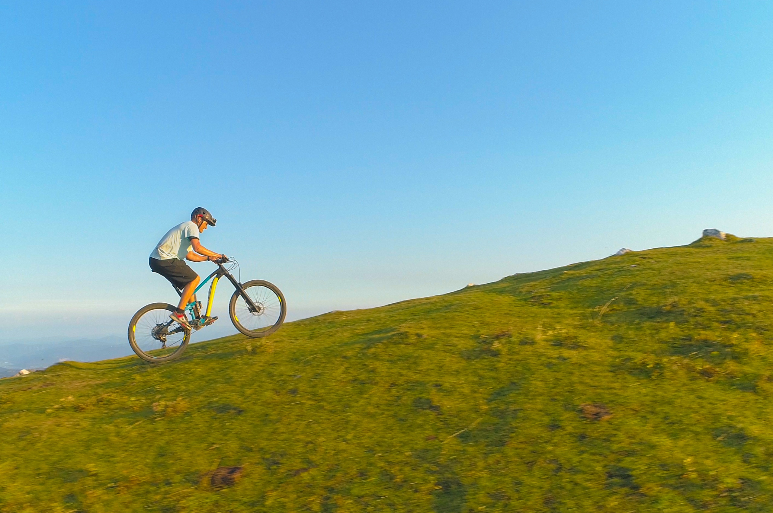 A man cycling uphill.